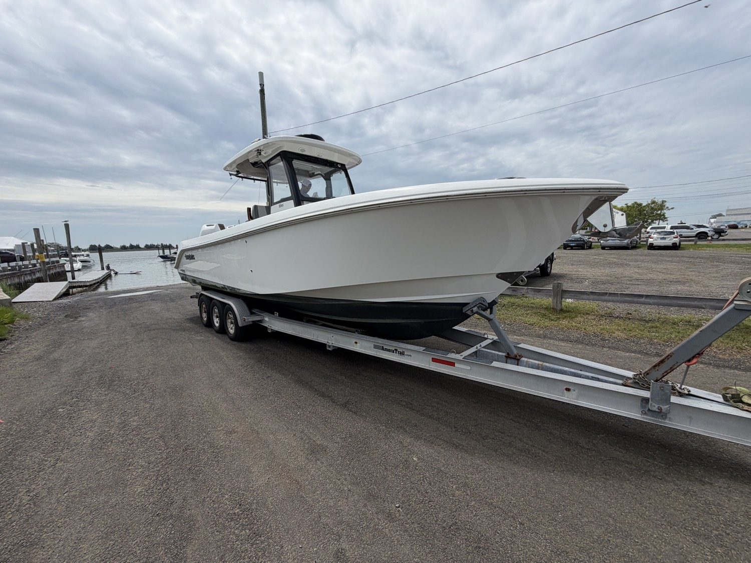 White center console on a triple-axle trailer at the water