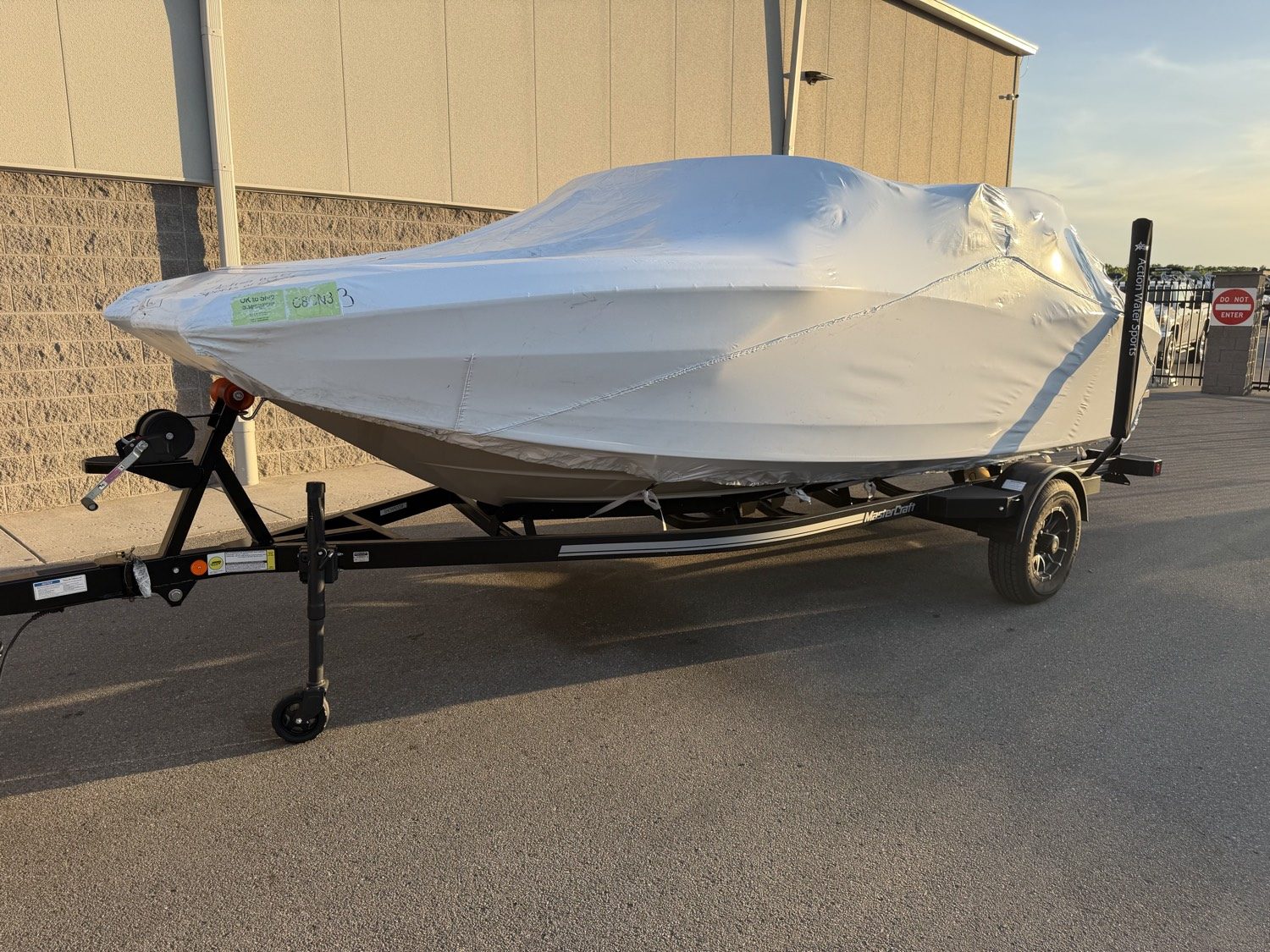 Covered boat on a MasterCraft trailer, ready to roll